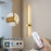 Gold wall light fixture with remote control and smartphone app compatibility.