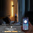 Person using a smartphone app to control a wall-mounted light in a bedroom.